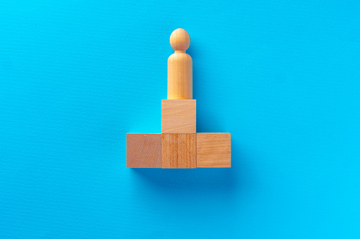 Top view of wooden toy blocks on blue background