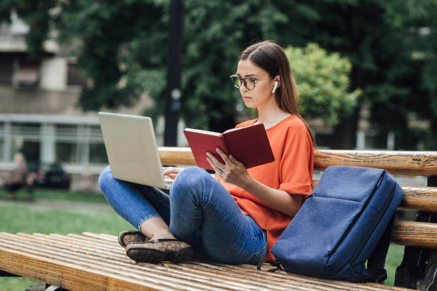 istock Girl learning in the park 1414424273