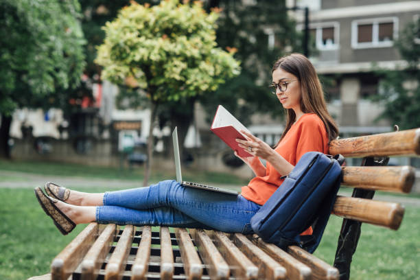 istock Girl enjoying studying in the park 1414424293