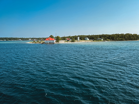 Long view of the South end of St. James, Beaver Island in Northern Michigan, USA. Nautical views of a beach and lighthouse as well as Central Michigan University Biological Station.