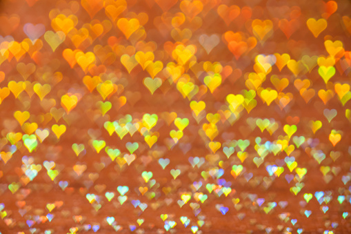 Gold heart shape lights bokeh abstract background holiday