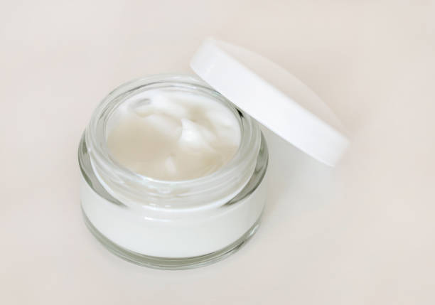 istock Opened Cosmetic jar with a lid on white close up, mockup. Everyday skincare routine 1414426909