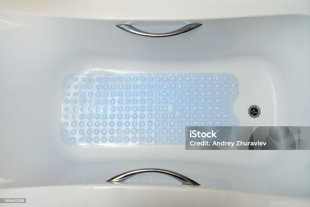 Non-slip blue mat with pimples in the bathroom Anti slip carpet in the bathroom for washing Mat Stock Photo