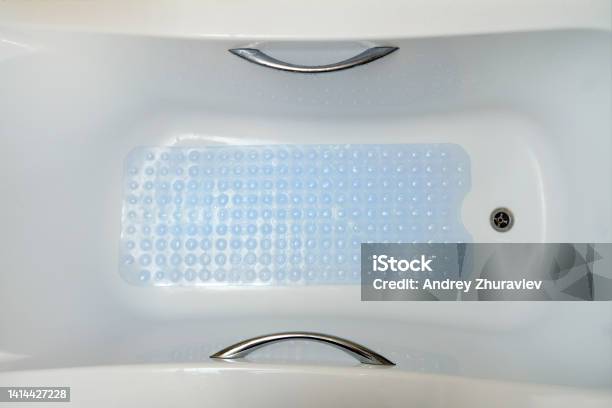 Nonslip Blue Mat With Pimples In The Bathroom Anti Slip Carpet In The Bathroom For Washing Stock Photo - Download Image Now