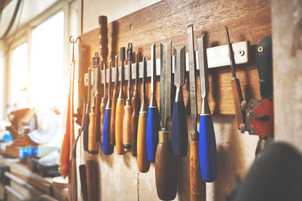 istock Empty workshop with DIY tools and equipment. Set of screw drivers and carpenter files hanging in the garage. Repair shop and woodwork hardware for crafting, building or repairing wooden furniture 1414428797
