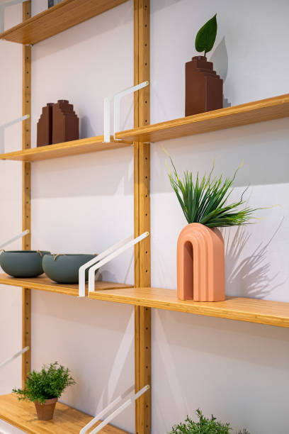 istock Interior wooden stand with shelves, plants, bowls and decorative elements. 1414429163