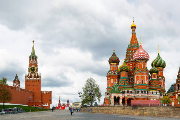 istock St. Basil's Cathedral on Red square and Moscow Kremlin with Spasskaya tower on a dramatic cloudy sky background. 1414432780