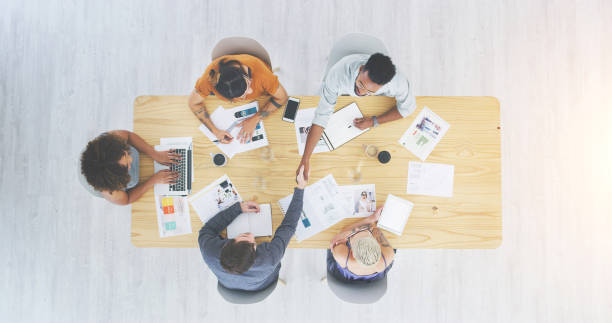 istock Group of designers sitting, working together and planning for a creative and innovative inspiration. Teamwork, talking and discussing businesspeople thinking and searching on strategy for project. 1414434445