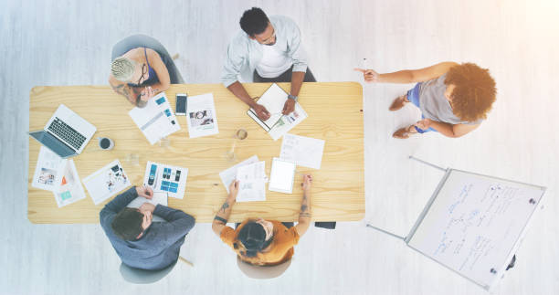 istock Planning, innovation and growth meeting between web designers thinking of creative ideas from above. Entrepreneur showing good leadership sharing vision and mission development presentation with team 1414434466