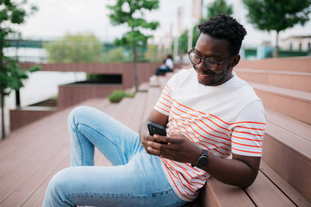 istock Young adult man using a smart phone outdoors 1414434735