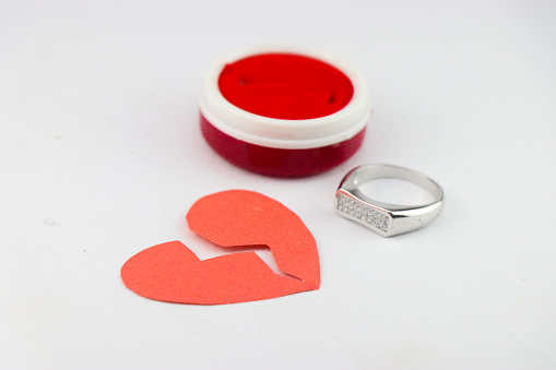 Red heartbreak or broken heart shows the concept of failed proposal or divorce after marriage