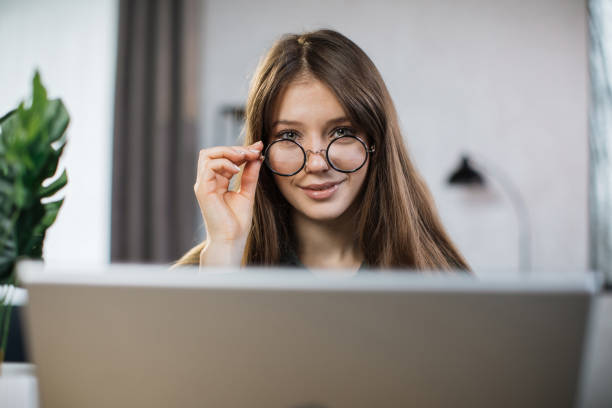istock Female freelancer talking and working while sitting at office. 1414440682