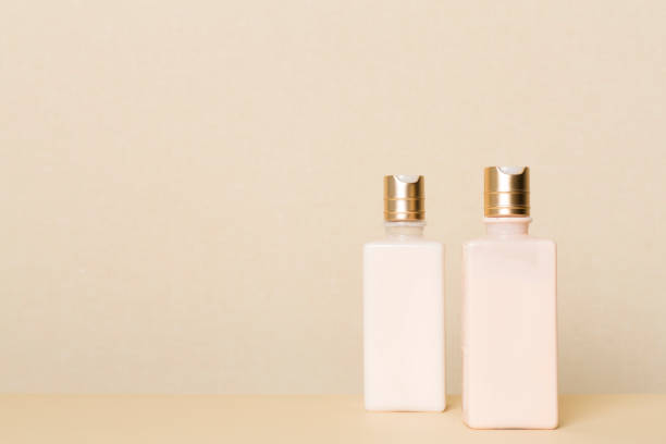 istock Bottles of cosmetic products on table background against light wall 1414441464