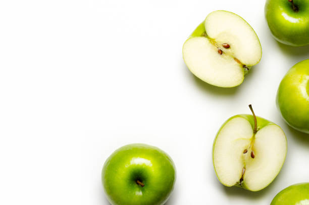 Green apples Whole and sliced green apples on white background with copy space. green apple slice stock pictures, royalty-free photos & images