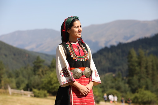 Koprivshtica, Bulgaria - August 6, 2022: People in traditional folk costume of The National Folklore Fair in Koprivshtica. The National Folklore Fair in Koprivshtica is entered in the UNESCO Register of the human intangible cultural heritage