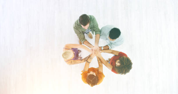 istock Trust, support and unity by a team joining hands and starting a business together. Above community, partners and teamwork with group of diverse professionals with ideas, vision or goal for a startup 1414446505