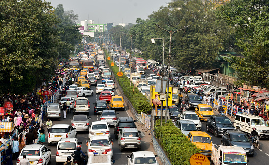 Kolkata, West Bengal / India - 12 29 2021: High angle view of many private cars, yellow cabs on the street traffic jam.