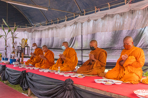 Luang Prabang, Laos - March 15th 2023: Young man in a monks dress - in Laos almost all men are monks in periods of their lives, many as an alternative to be drafted to the army