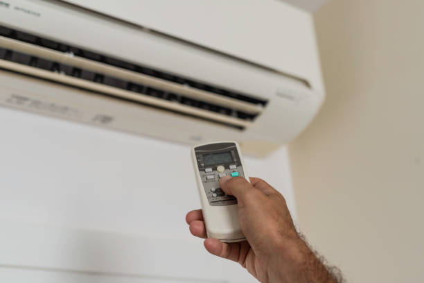 istock Unrecognizable person operating the air conditioner with remote control 1414449892