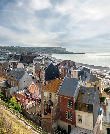 wide panoramic view down on Mers-Les-Bains and the beach with white wooden huts and the steep coast in the background