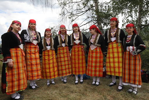 Koprivshtica, Bulgaria - August 6, 2022: People in traditional folk costume of The National Folklore Fair in Koprivshtica. The National Folklore Fair in Koprivshtica is entered in the UNESCO Register of the human intangible cultural heritage