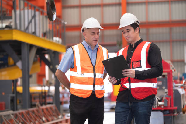 istock Two people staff audit team checking safety in factory, Engineer talking training coworker team company 1414453081