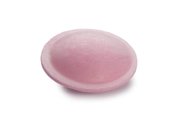 Studio shot of 1950/60s style sherbet flying saucers sweets cut out against a white background.