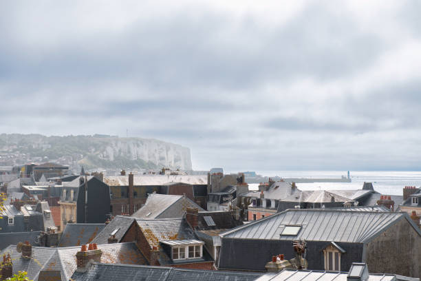 wide panoramic view down on Mers-Les-Bains and the beach with white wooden huts and the steep coast in the background