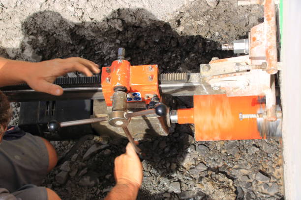 istock Worker drills a core hole hole into a house wall 1414456205