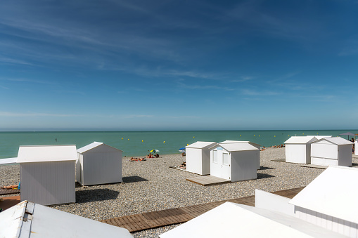 white traditional wooden beach huts at the beach in Mers-Les-Bains at the atlantic coast