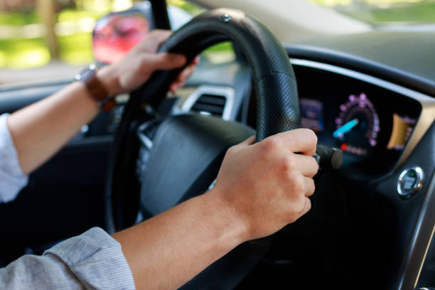 istock man holding hands on steering wheel close up 1414456701
