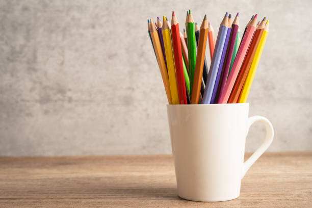 istock Colorful pencils in white cup with copy space, learning university education concept. 1414457084