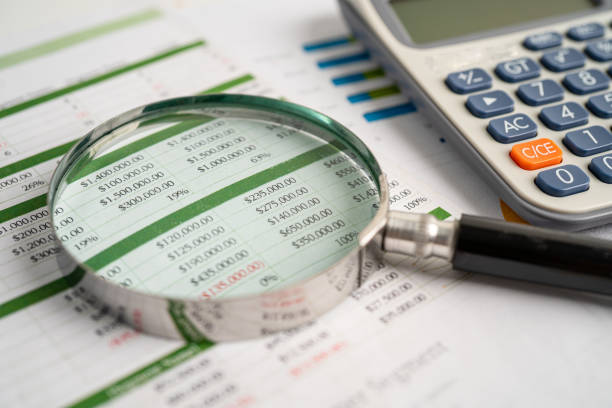 istock Magnifying glass on spreadsheet and calculator. Financial development, Banking Account, Statistics, Investment Analytic research data economy, Stock exchange trading, Business office concept. 1414457113
