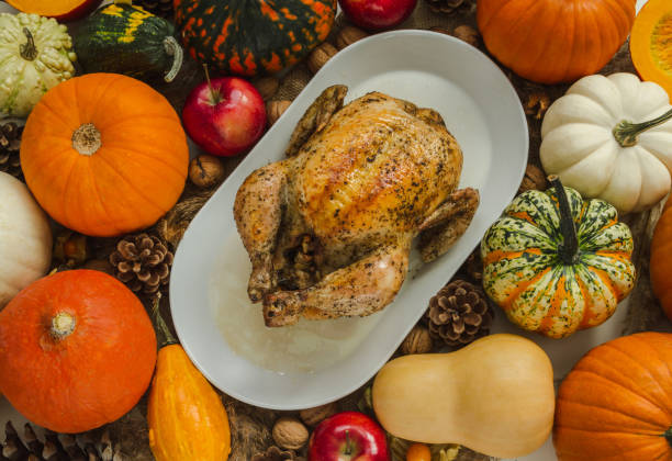 istock Thanksgiving dinner composition, with roasted chicken and pumpkins. 1414457964