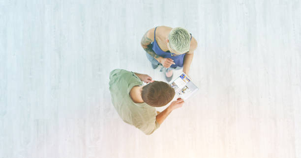 istock Business people working on tablet talking or collaborating on design project, marketing strategy or monitoring social media with copy space. Above of trendy marketers looking at online data copyspace 1414460087