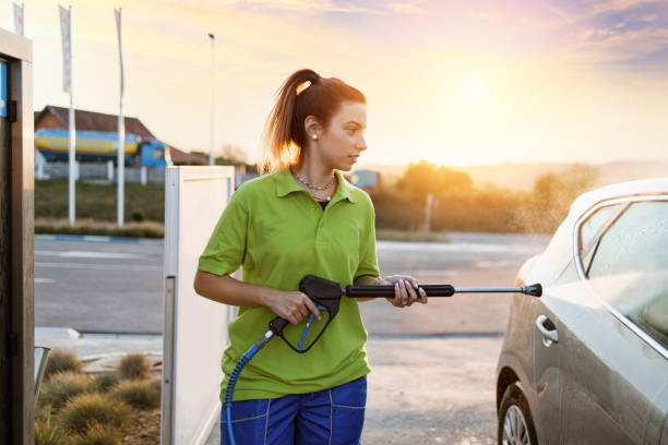 istock Beautiful female worker at car wash service. 1414460263