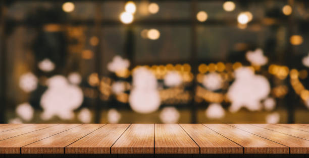 istock Empty wooden table top with lights bokeh on blur restaurant background. 1414460276