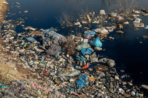 istock Close up of toxic pond with trash 1414464901