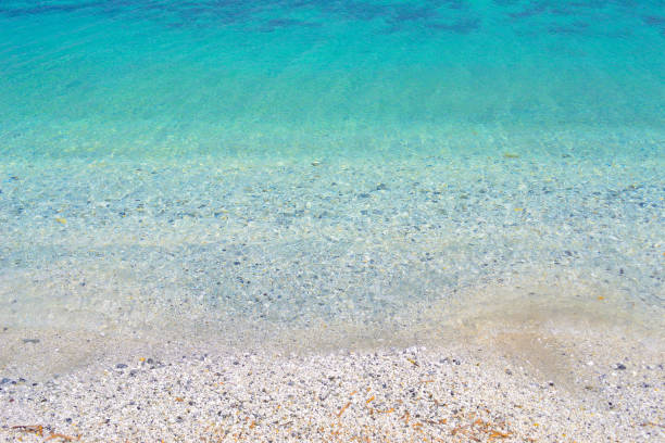 Beautiful view of wavy sea and pebbles on beach