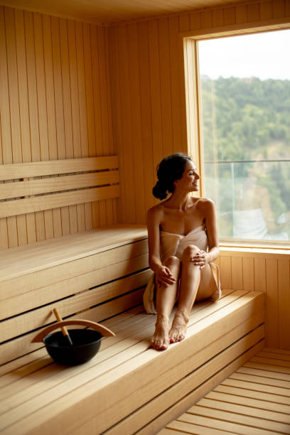 istock Young woman relaxing in the sauna 1414466342