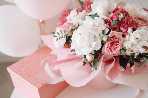 Bouquet of peonies and gift pink box, birthday concept stock photo