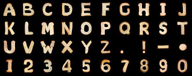 Bread alphabet on black background