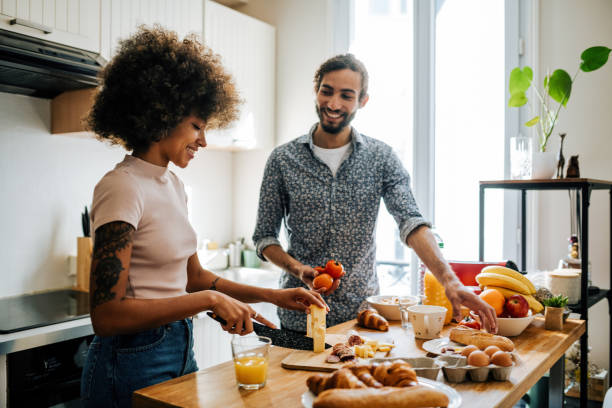 istock Passionate multi ethnic couple in kitchen preparing food and having fun 1414470969