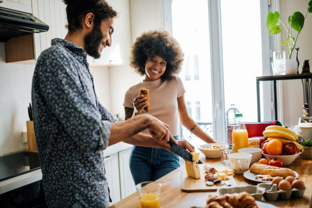 istock Passionate multi ethnic couple in kitchen preparing food and having fun 1414471080