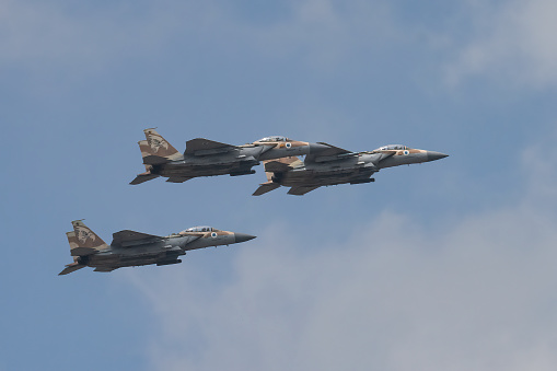 Jerusalem, Israel - May 5th, 2022: Three israeli air force McDonnell Douglas F-15 Eagle aircrafts, flying in a hazy sky.