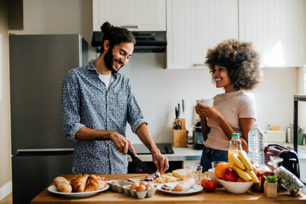 istock Passionate multi ethnic couple in kitchen preparing food and having fun 1414471089