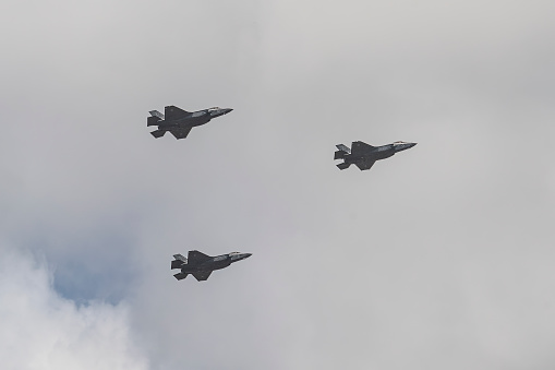 Jerusalem, Israel - May 5th, 2022: Three israeli air force Lockheed Martin F-35 aircrafts, flying in a hazy, cloudy sky.