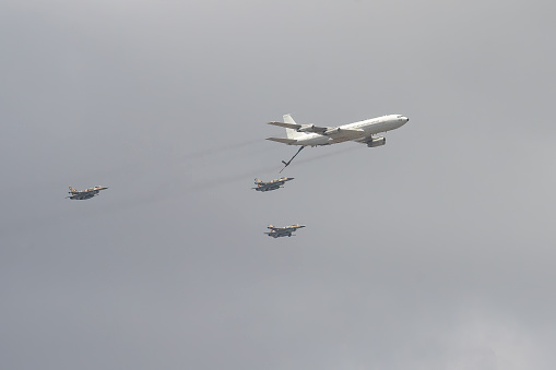 Jerusalem, Israel - May 5th, 2022: Three israeli air force General Dynamics F-16 aircrafts, demonstrating aerial refueling by a Boeing 707 airplane.