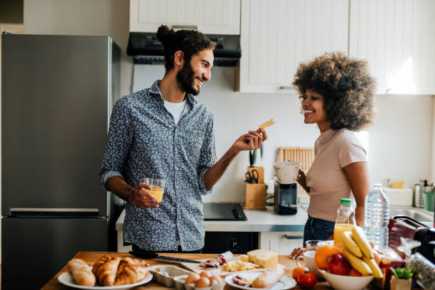 istock Passionate multi ethnic couple in kitchen preparing food and having fun 1414471130