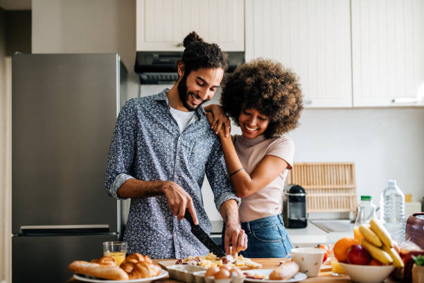 istock Passionate multi ethnic couple in kitchen preparing food and hugging 1414471699